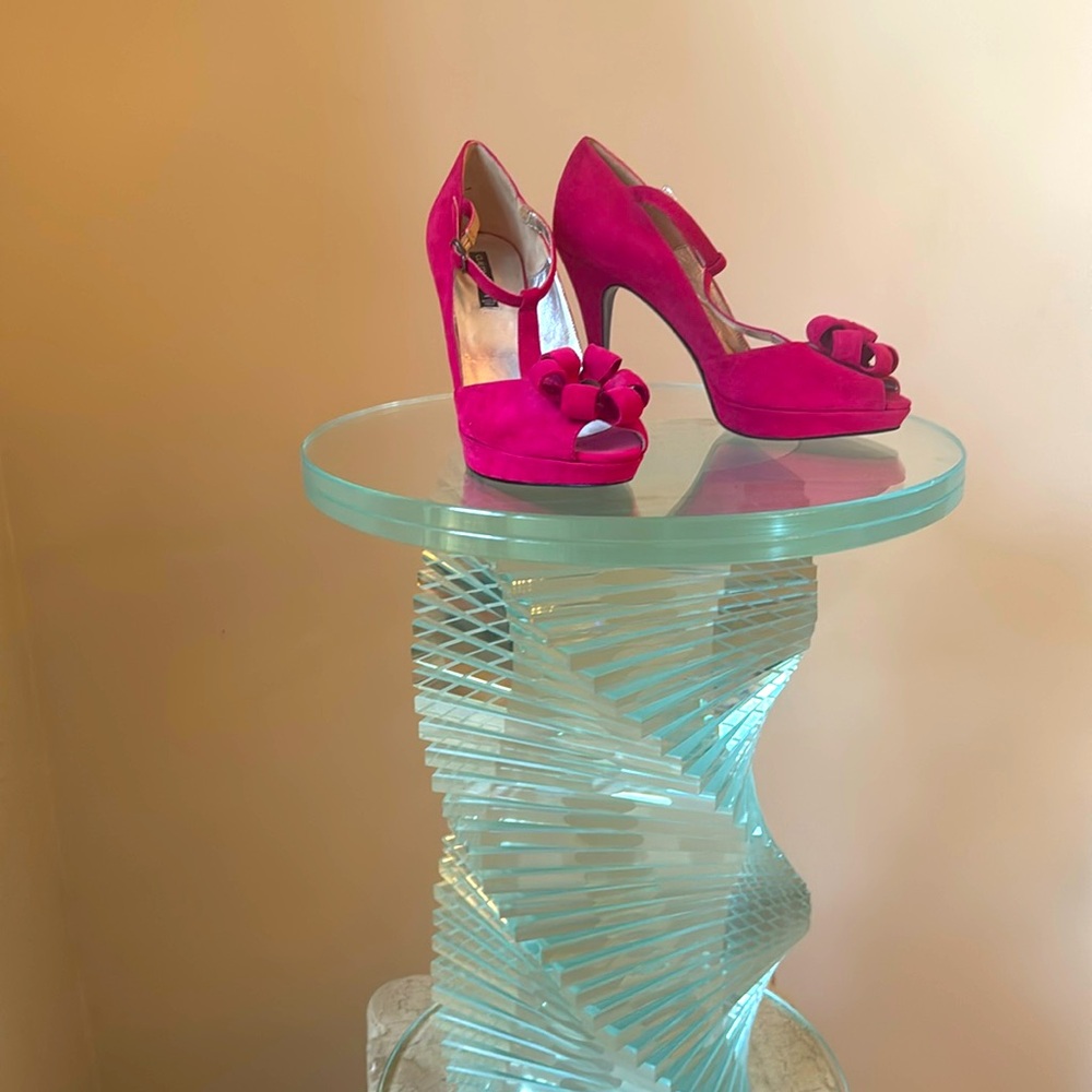 A pair of Claudia Ciuti hit pink side high heals